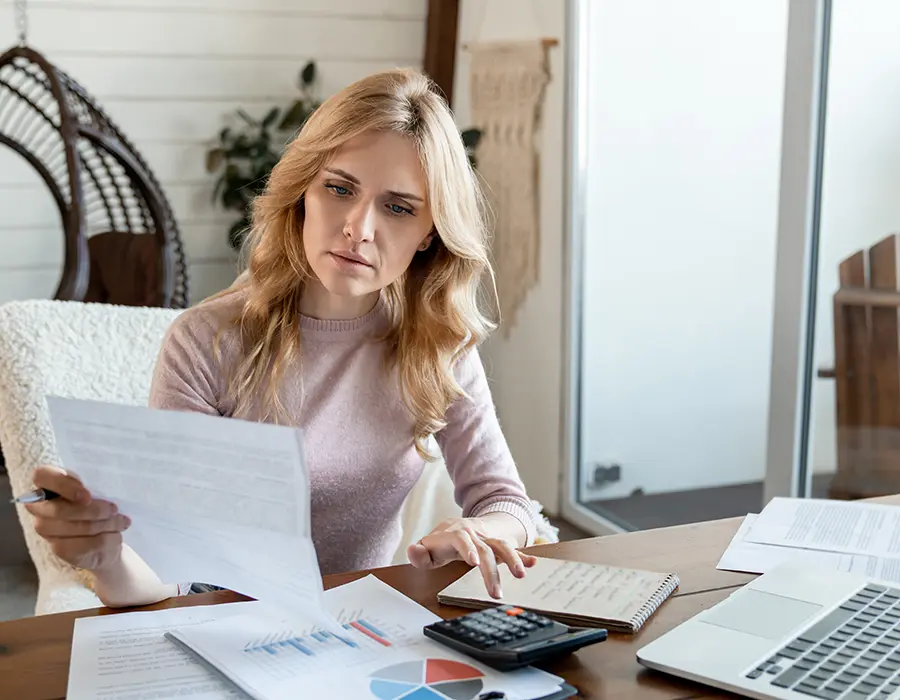 woman on laptop with papers
